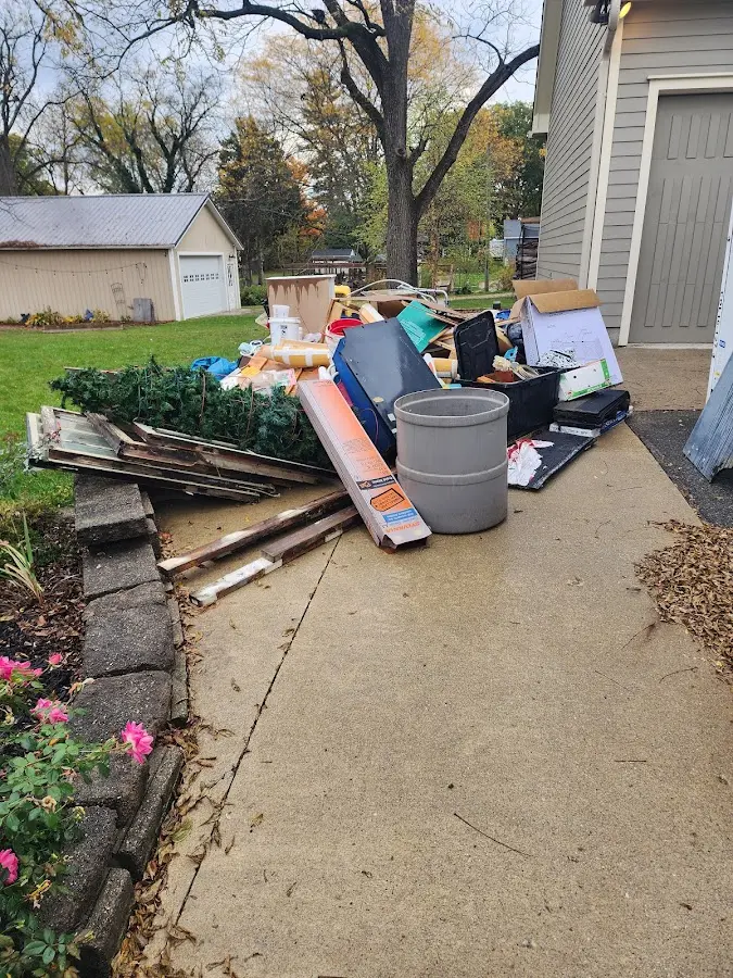 Dumpster being loaded with debris for 12 Yard Dumpster Rental in Barre